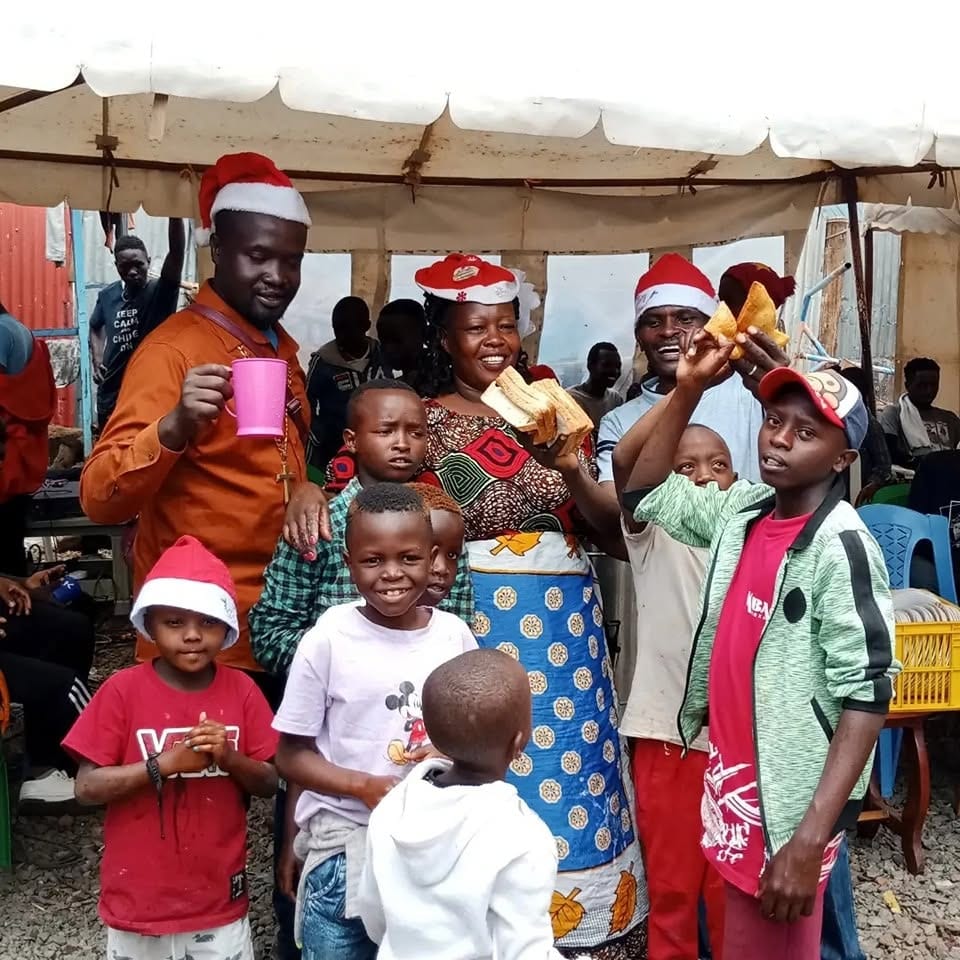 The founder and caregivers celebrating with the children